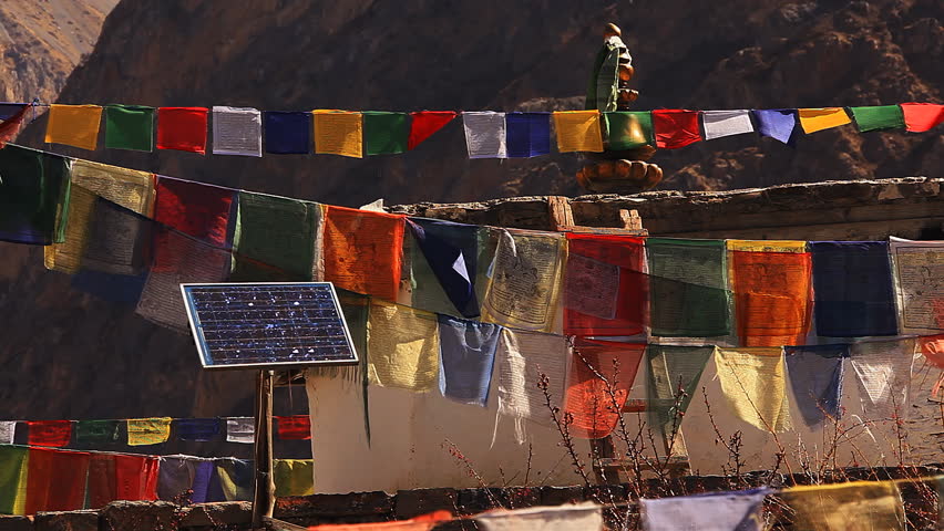 Solar panel among Tibetan prayer flags. Nepal, Himalayas.