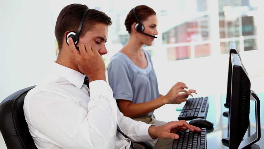 Business man and business woman working in a call centre