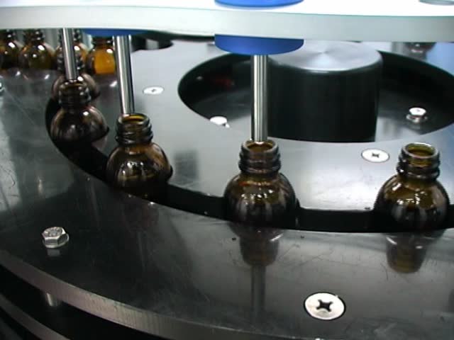 Close-up on a liquid medicine production line.