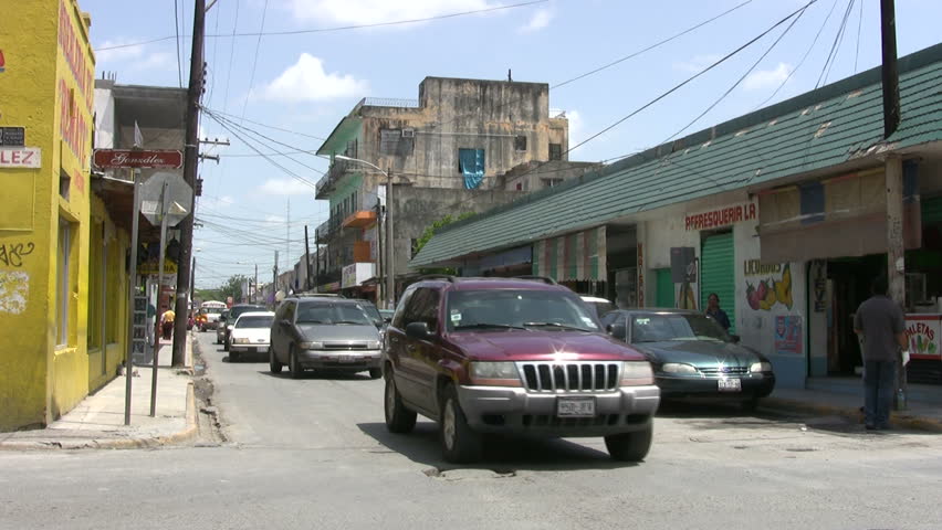 Video of the border city of Matamoros Mexico city street.  Across from Brownsville TX. Mexicans and tourist walking around very old run-down buildings. Poor. Don Despain of Rekindle Photo