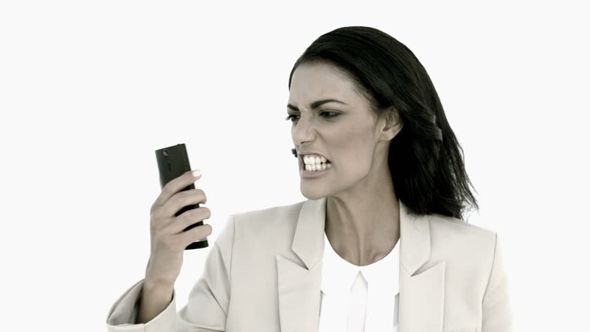 Businesswoman screaming down her mobile phone in black and white in slow motion