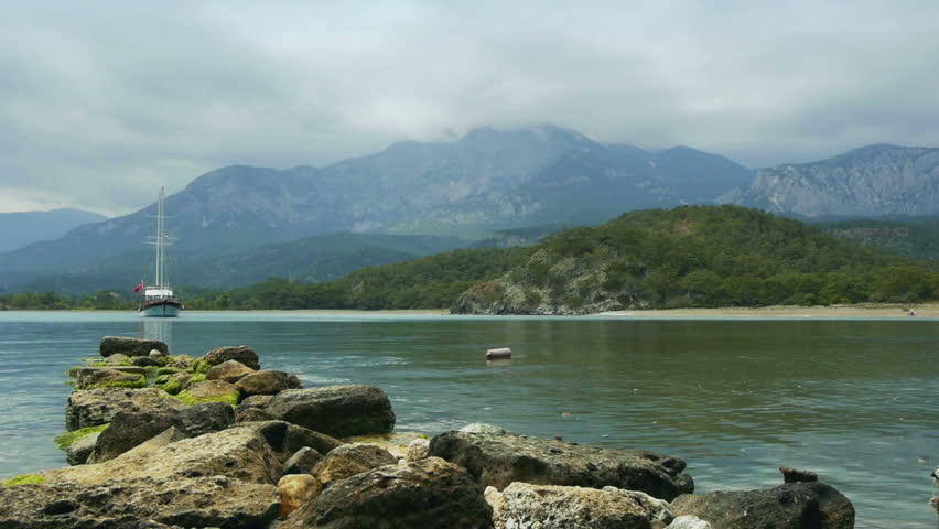Touristic ship moored near the shore of  ancient Greek and Roman city Phaselis, Turkey