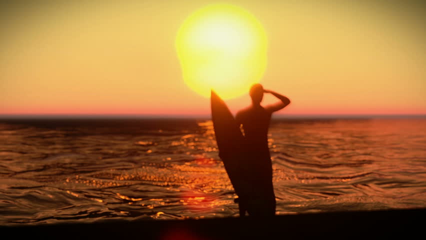 Silhouette of a surfer with his surfboard on the sunset
