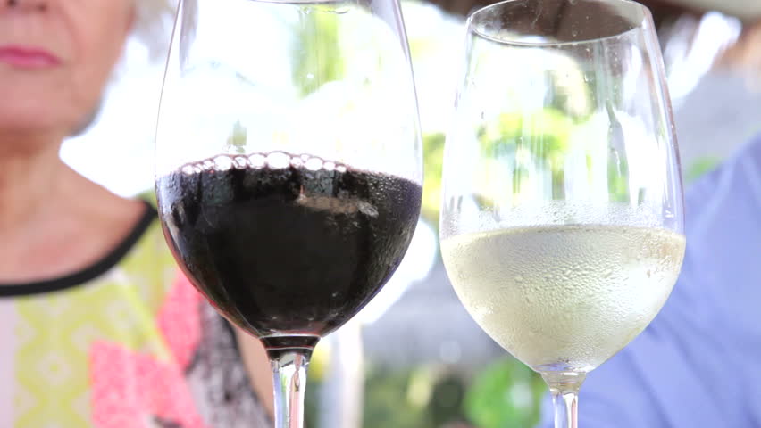 Close Up Of Senior Couple Toasting With Wine Glasses
