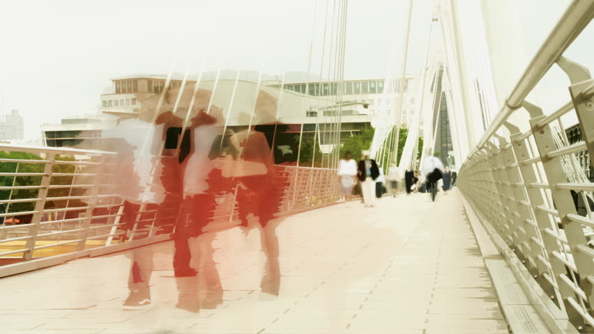 time-lapse shot of people crossing waterloo foot bridge, london, using an ND filter to achieve longer exposures in daylight conditions