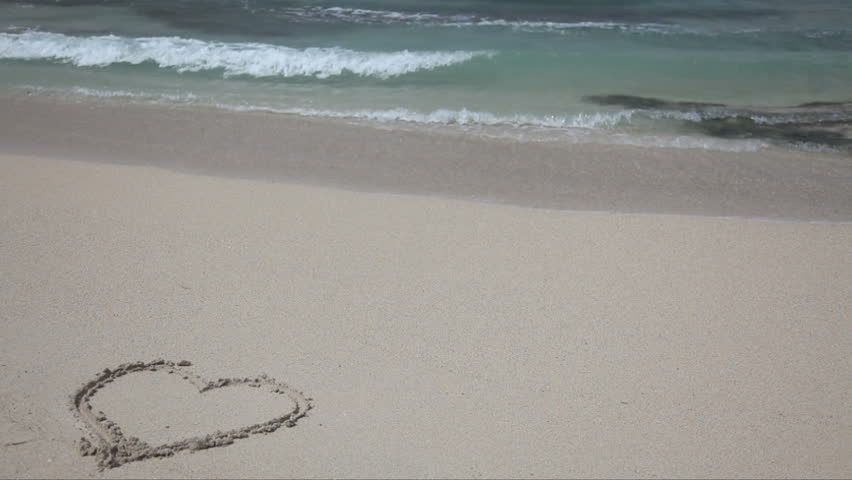 Heart on the sand, washed out by the waves