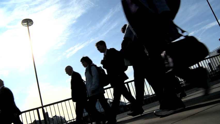 Silhouettes of city commuters in slow motion