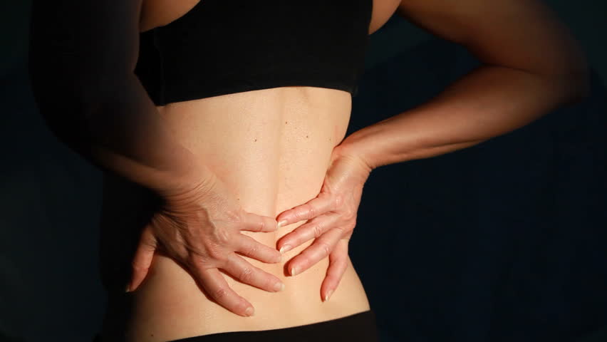 A close up of a woman back who is dealing with backache.