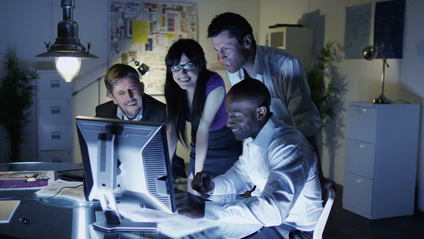 Business Team Working Late Into The Evening In Creative Office Stock - 852x480 - jpeg Team Working Late