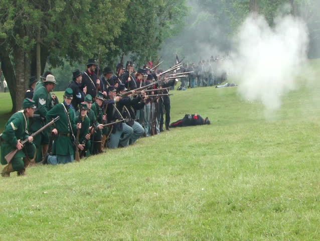 PORT GAMBLE, WA - JUN 20 2009: Civil War reenactors participate in a mock battle.	Union infantry line fires volleys at the enemy 