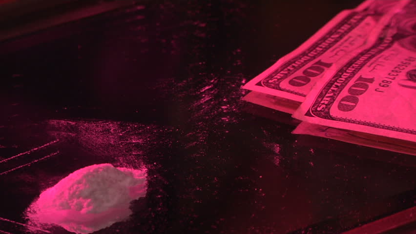 Snorting cocaine with paper bill