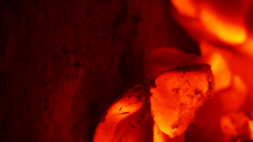Glowing, blazing wood embers of a dying fire. Clip Three