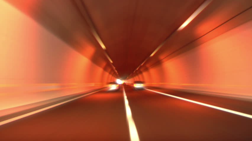 Driving through tunnel, abstract with motion blur and glow.