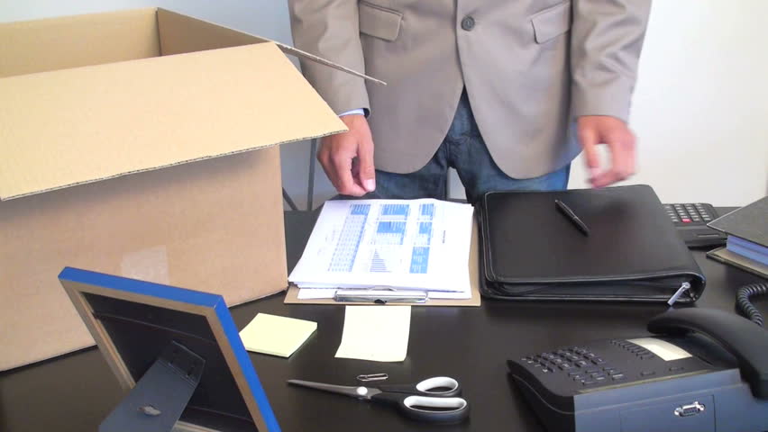businessman looses his employment and clears his desktop