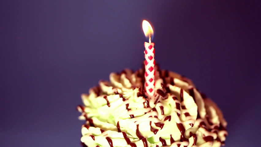 Candle on a small birthday cake