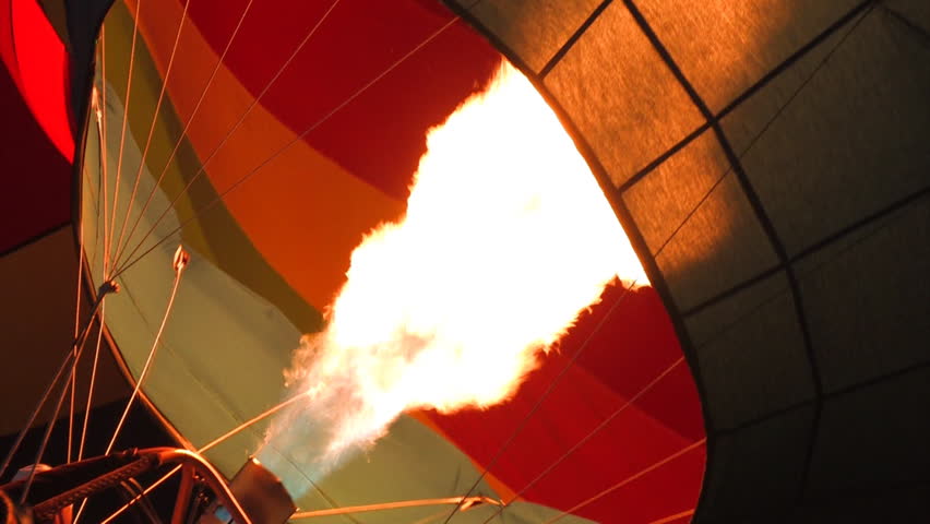 A hot air balloon gets inflated by propane gas.