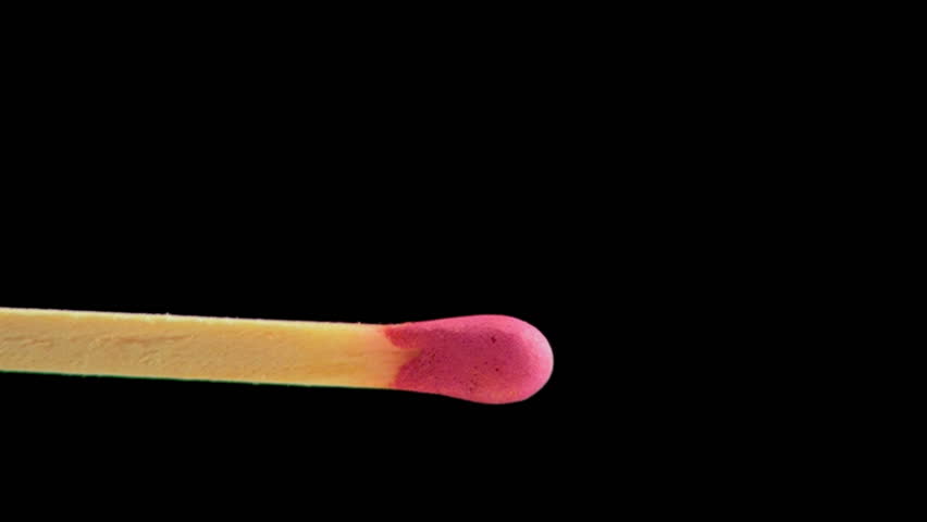 Spontaneous ignition of match on black background