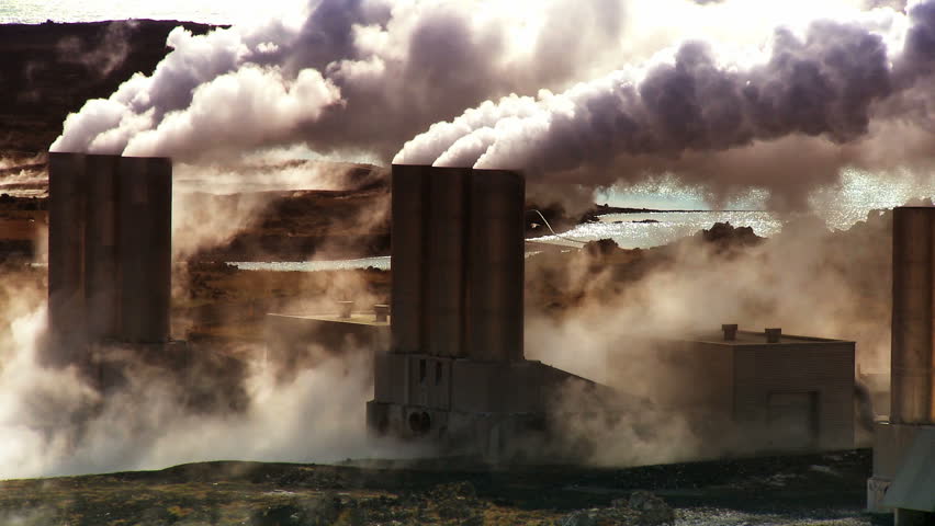 Steam from geothermal energy being piped to power plant from natural volcanic hot springs