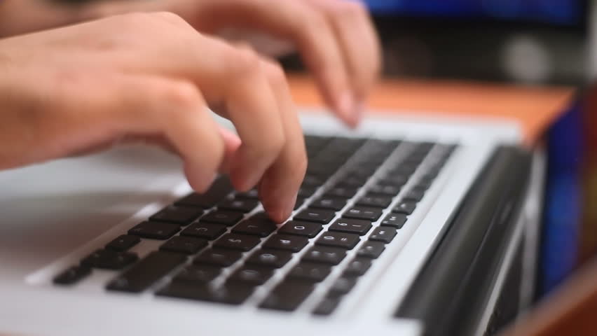 Hands typing on computer keyboard 