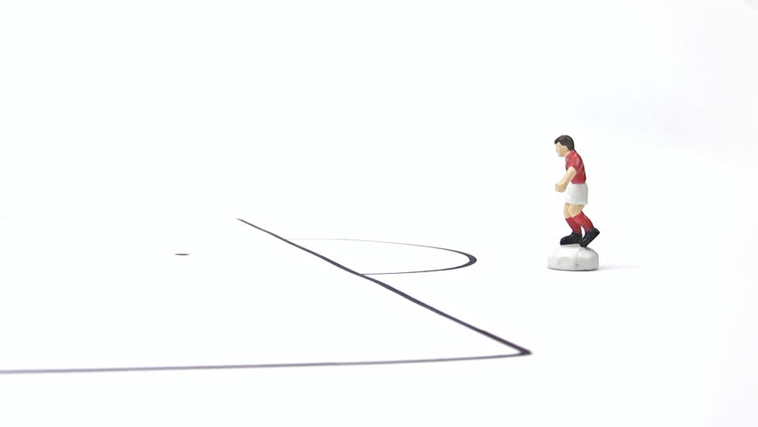 Figurine of football player exercising in a penalty box. isolated on white