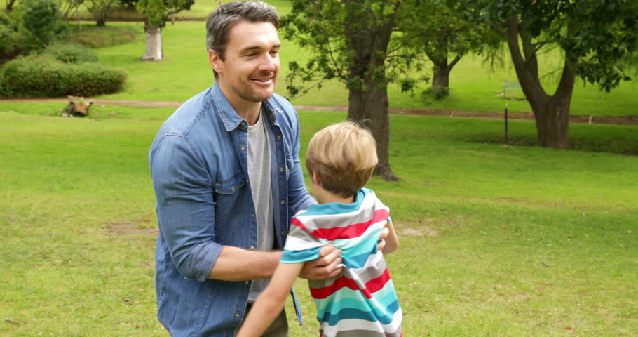 Father and son playing in the park on a sunny day