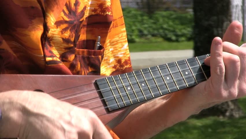 A Street Busker Playing Ukelele Slow. 