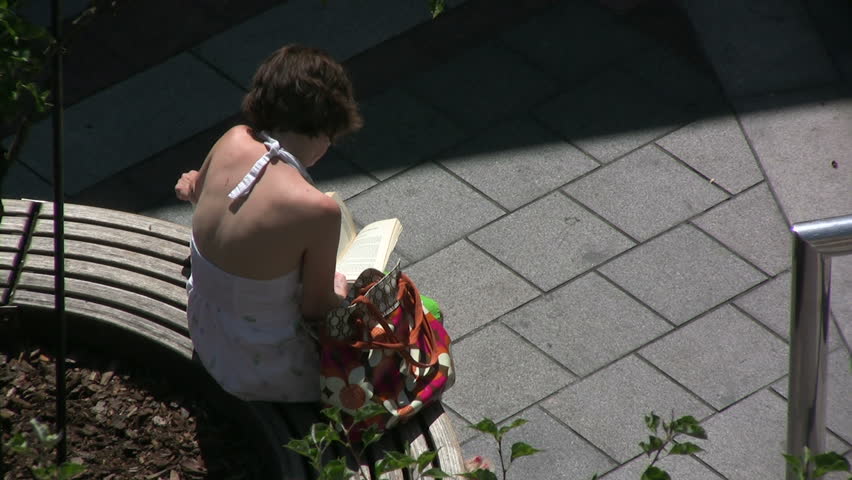 Girl reading in a park. HD 1080i