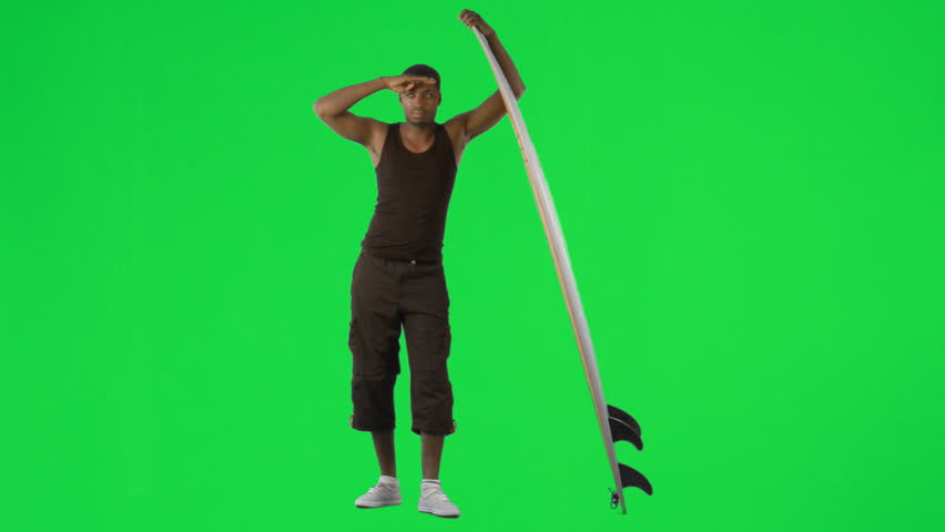 Ethnic boy with a surfboard against green screen