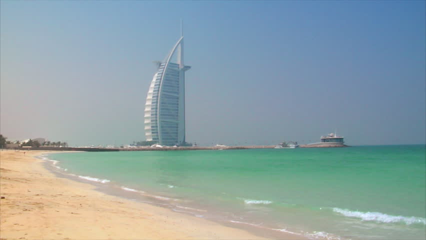 DUBAI - SEPTEMBER 10: Jumeirah Beach with a male Jogger in front and the Burj al Arab in the background, Dubai at Jumeirah Beach on September 10.2009, Dubai, UAE. Joggers face is not visible.