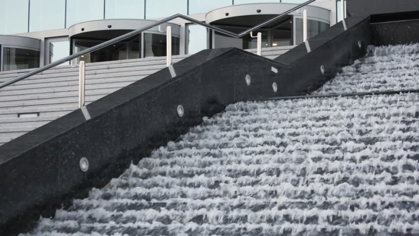 flowing water in stepped fountain with ladder 