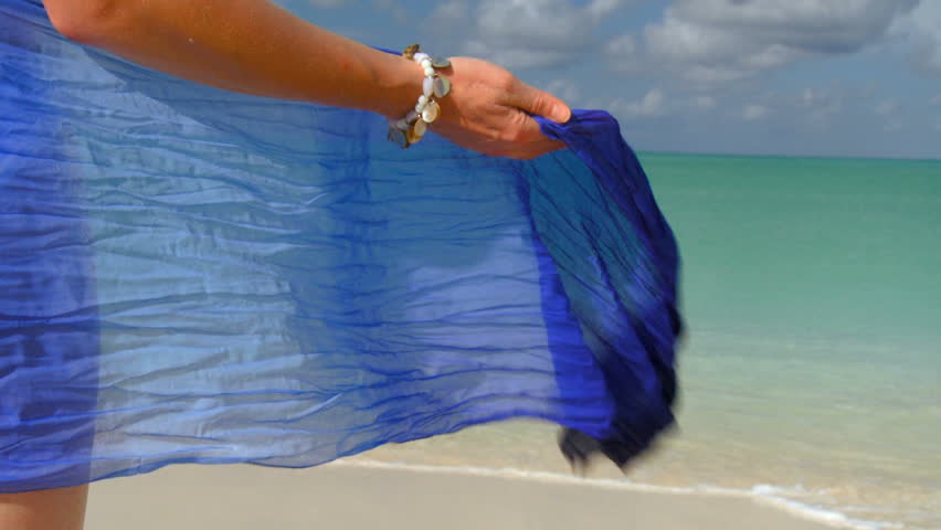 Elegant young female in swimwear on a beautiful white sandy beach looking at aquamarine waters 60 FPS