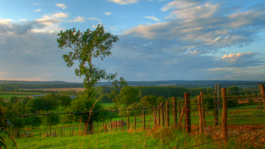 Sunset over fields and hills, HD motion time lapse clip, high dynamic range imaging