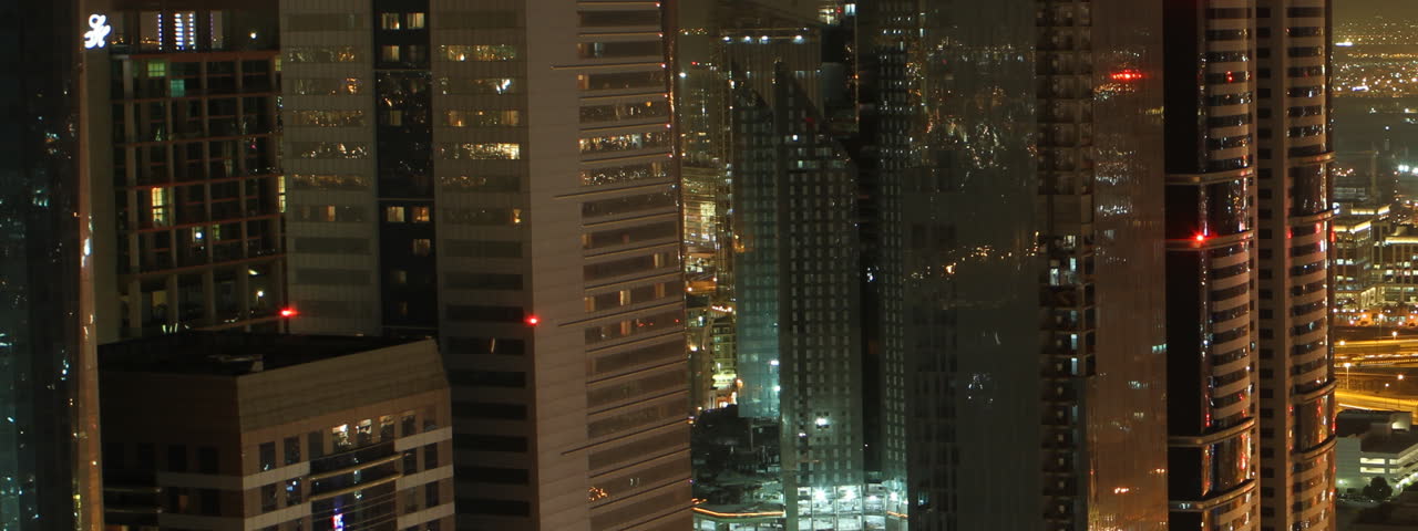 pan shot dubai skyscrapers and traffic by night, time lapse