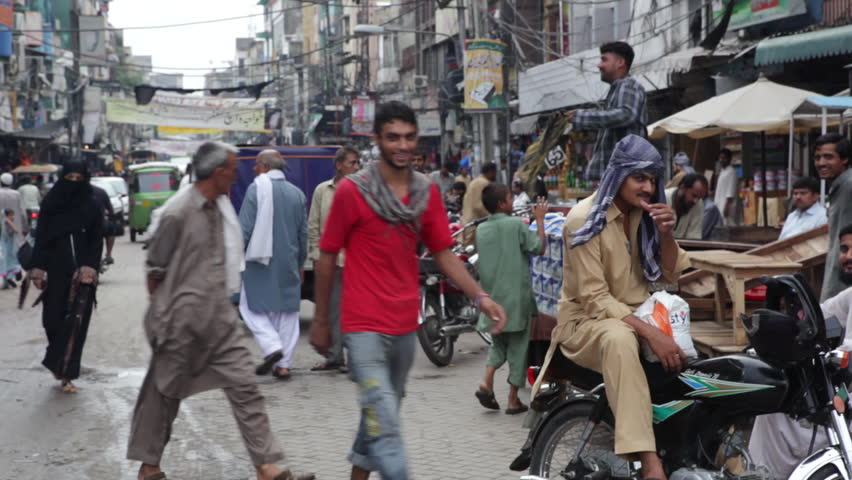 Lahore, Pakistan - July 23, 2013: People Crossing A Noisy, Crowded 