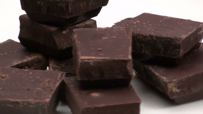 Seamless loop of delicious dark chocolate isolated against white