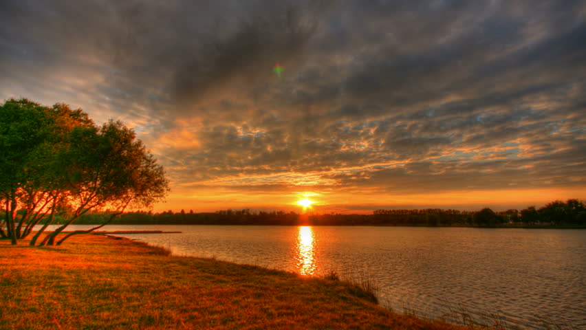 Beautiful sunset over lake, HD time lapse clip, high dynamic range imaging
