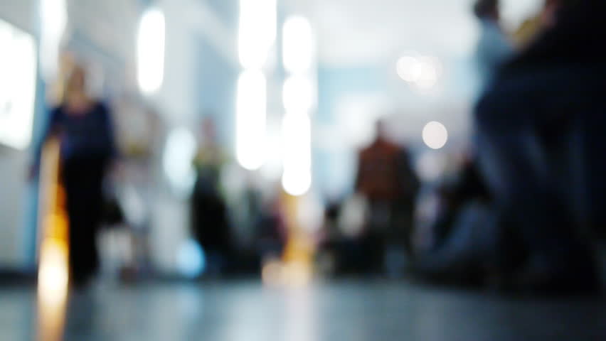 Defocused anonymous Crowd in the hall with Sound. Slow motion.