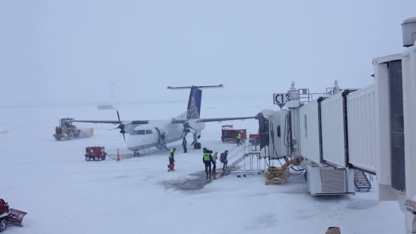 DAYTON, OH - FEBRUARY 15: A Continental Express Aircraft unloads luggage during a heavy snow storm  on Monday February 15, 2009 in Dayton, Ohio.