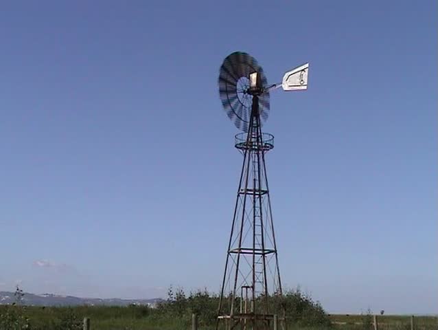 Windmill working in farmland