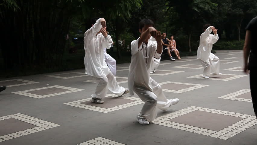 Chengdu, China - August 10: Chinese man and woman dressing white silk practice balancing Tai Chi in the People's Park daily - Chengdu, China in Sichuan Province, August 10, 2009