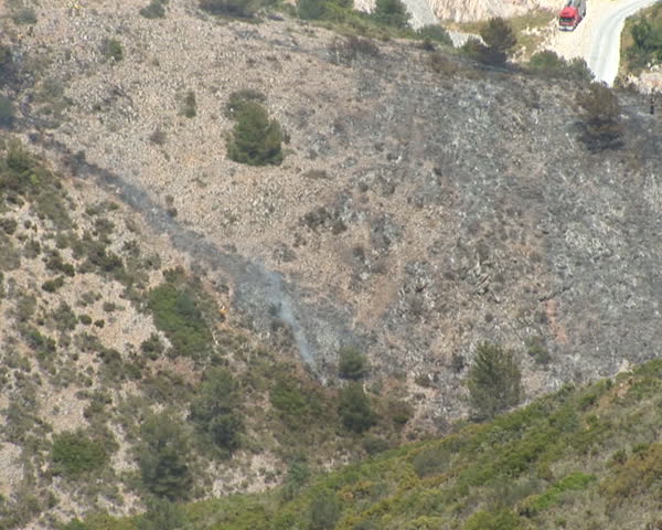 PAL: Fire chopper dumps water on brush fire.