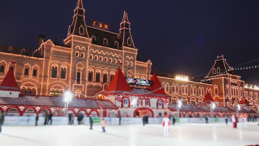 skating rink with people on Red Square at GUM in evening in Moscow 