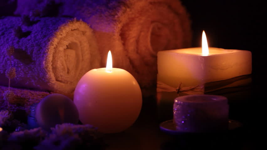 Spa accessories (moisturizer, candles, towels) at therapy center 