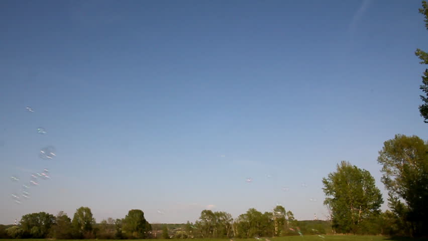 soap bubbles flying on blue sky background