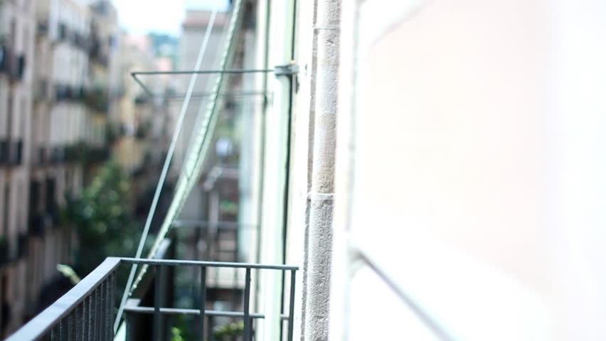 Woman looks from the balcony