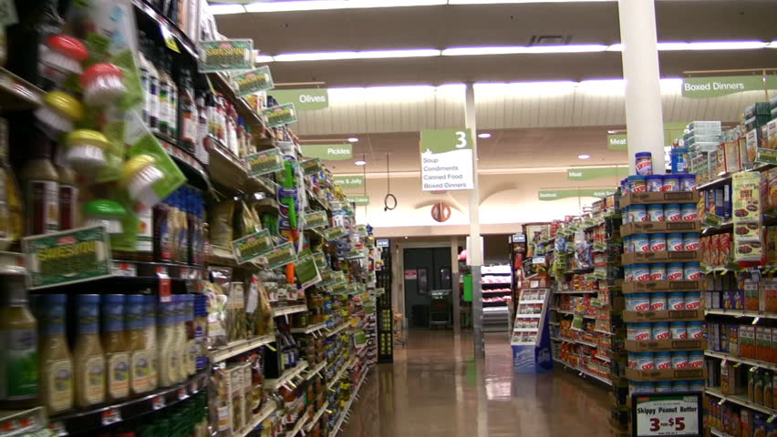 HD view from a wobbly cart going down a grocery store aisle