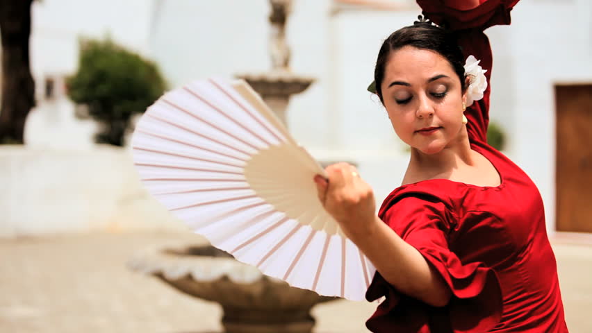 Beautiful lady dancing traditional spanish flamenco in town square Seville