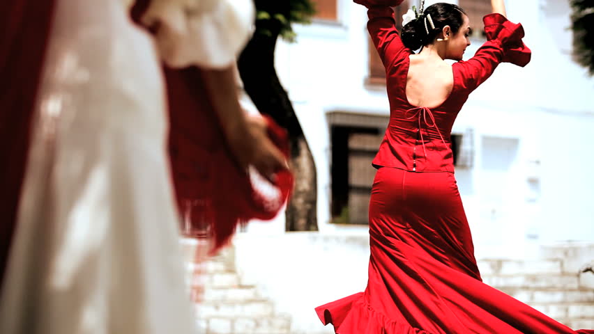 Two ladies dancing traditional flamenco in town square in Seville, Spain 