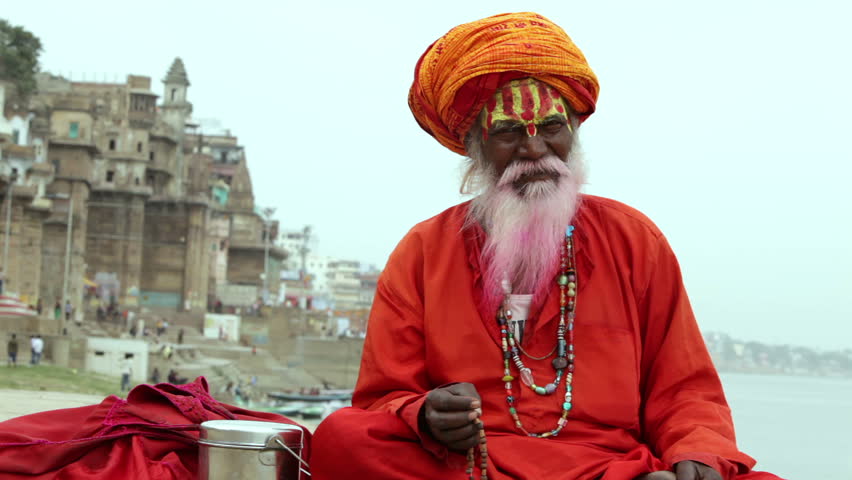 Sadhu at the ghats in Varanasi, India. With a pink beard from the traditional holi festival.