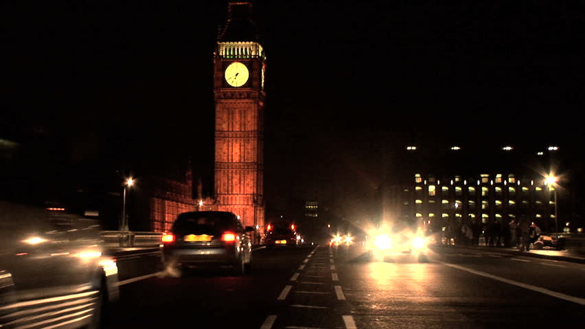 London skyline at night with Big Ben, & vehicles on Westminster Bridge